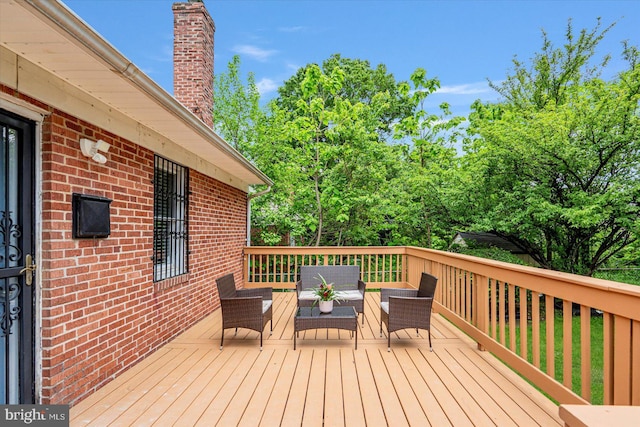 wooden terrace featuring an outdoor living space