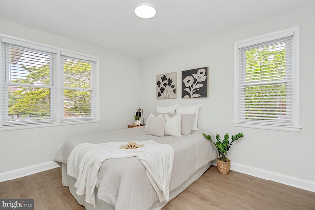 bedroom featuring baseboards and light wood-type flooring