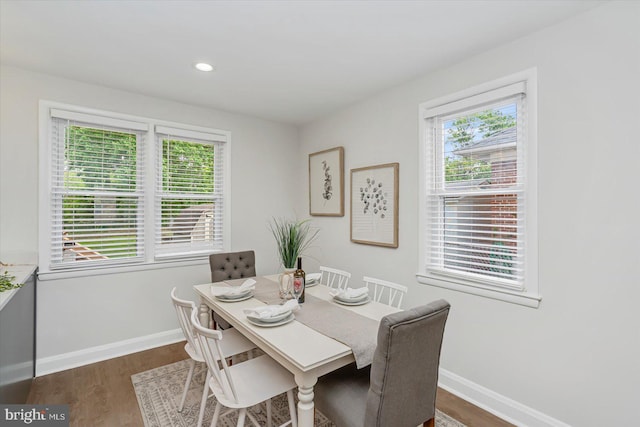 dining space with baseboards, dark wood-style floors, and recessed lighting