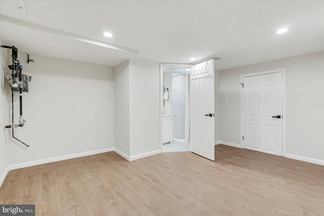 finished basement with light wood-style floors, baseboards, and recessed lighting