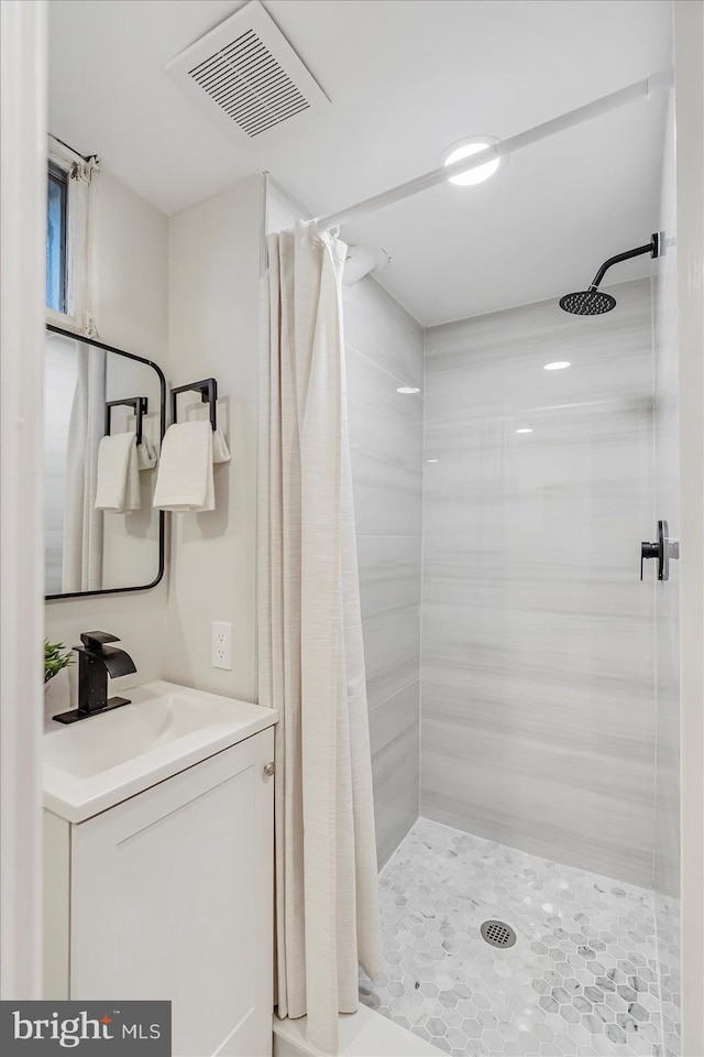 bathroom featuring a stall shower and vanity