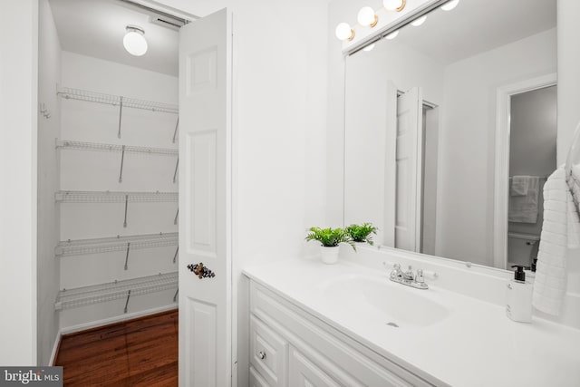 3901 Bradwater St, Fairfax, VA 22031 - bathroom featuring vanity, wood finished floors, and a closet