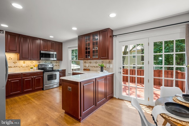 3901 Bradwater St, Fairfax, VA 22031 - kitchen with stainless steel appliances, a peninsula, light countertops, light wood-style floors, and recessed lighting