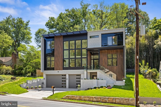 3554 Military Rd, Arlington, VA 22207 - contemporary house featuring a garage, concrete driveway, stairway, a front yard, and stucco siding