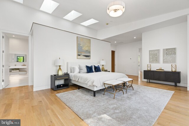 3554 Military Rd, Arlington, VA 22207 - bedroom featuring a skylight, light wood-style flooring, recessed lighting, and connected bathroom