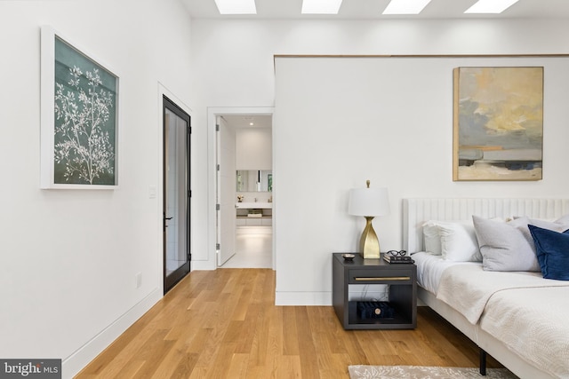 3554 Military Rd, Arlington, VA 22207 - bedroom featuring light wood-style floors, a skylight, baseboards, and ensuite bath