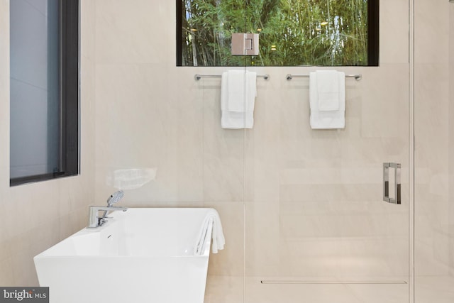 3554 Military Rd, Arlington, VA 22207 - full bathroom featuring tile walls, a sink, a soaking tub, and a shower stall
