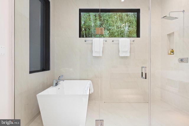 3554 Military Rd, Arlington, VA 22207 - bathroom with a stall shower, a freestanding tub, a sink, and tile walls