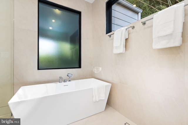 3554 Military Rd, Arlington, VA 22207 - full bathroom with a freestanding bath, a sink, and tile walls