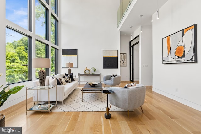 3554 Military Rd, Arlington, VA 22207 - living room featuring a towering ceiling, light wood finished floors, and baseboards