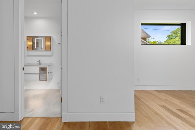 3554 Military Rd, Arlington, VA 22207 - unfurnished bedroom with wood finished floors, a sink, and baseboards