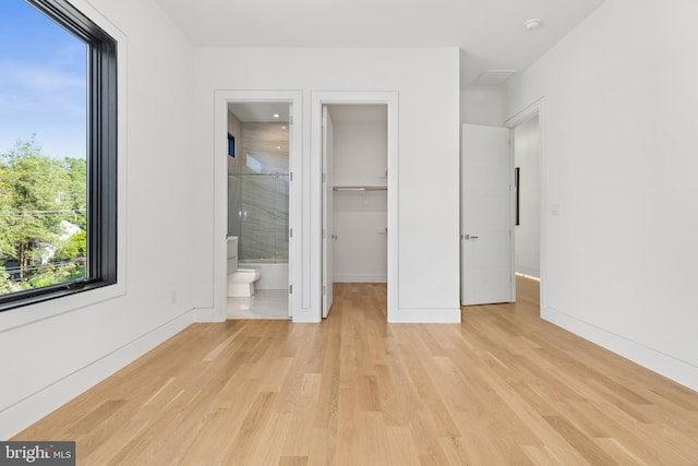 3554 Military Rd, Arlington, VA 22207 - unfurnished bedroom with light wood finished floors, multiple windows, and a spacious closet