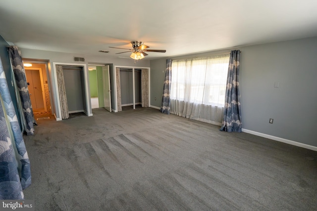 334 Windsor St, Wyomissing, PA 19610 - unfurnished bedroom with two closets, baseboards, a ceiling fan, and carpet flooring