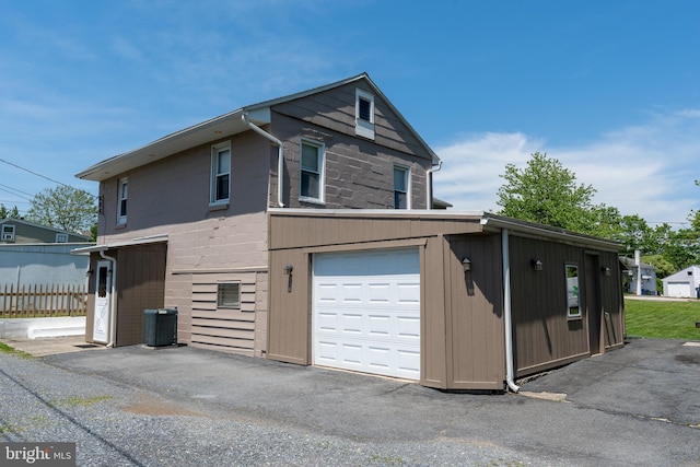 334 Windsor St, Wyomissing, PA 19610 - view of property exterior featuring central air condition unit, an attached garage, and fence