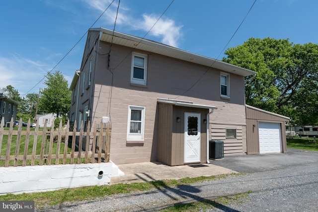 334 Windsor St, Wyomissing, PA 19610 - view of front of home with driveway, fence, central AC unit, an attached garage, and concrete block siding