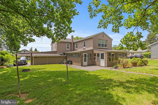 334 Windsor St, Wyomissing, PA 19610 - back of house featuring a sunroom, a lawn, and a patio area