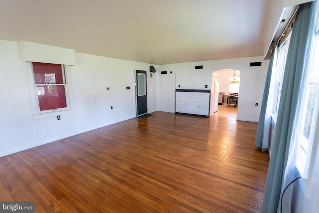 334 Windsor St, Wyomissing, PA 19610 - unfurnished living room featuring arched walkways, dark wood-style flooring, and baseboards