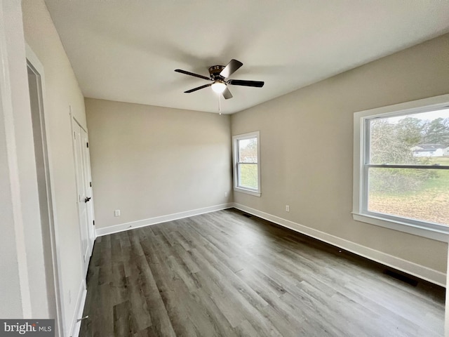 826 S Glebe Rd, Montross, VA 22520 - unfurnished bedroom with baseboards, dark wood-style flooring, and a ceiling fan