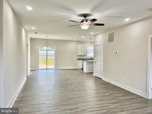 826 S Glebe Rd, Montross, VA 22520 - unfurnished living room featuring a ceiling fan, wood finished floors, baseboards, recessed lighting, and a sink