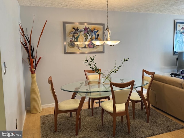 106 Perth Amboy Ct, Upper Marlboro, MD 20774 - dining area with a textured ceiling, wood finished floors, and baseboards