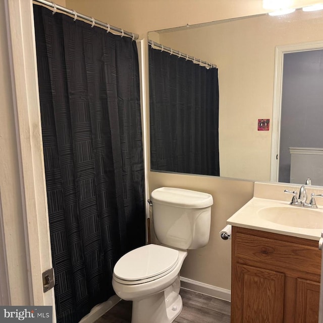 106 Perth Amboy Ct, Upper Marlboro, MD 20774 - bathroom with wood finished floors, baseboards, vanity, toilet, and curtained shower