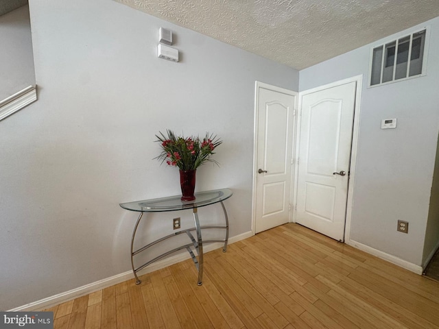 106 Perth Amboy Ct, Upper Marlboro, MD 20774 - corridor featuring light wood finished floors, baseboards, and a textured ceiling