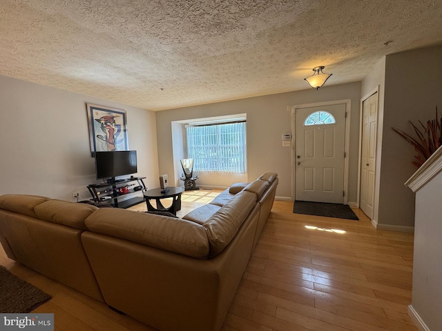 106 Perth Amboy Ct, Upper Marlboro, MD 20774 - living room featuring baseboards, a textured ceiling, and light wood finished floors