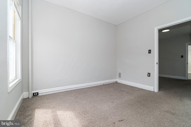 spare room with carpet floors and baseboards