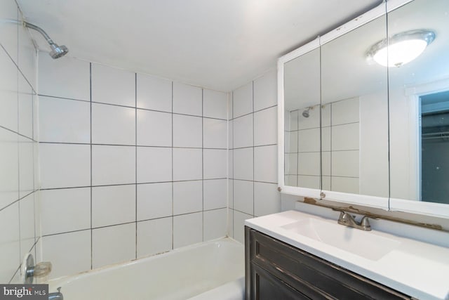 bathroom with vanity, shower / tub combination, and tile walls
