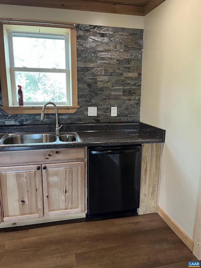 kitchen with dishwasher, a sink, light brown cabinetry, and dark countertops