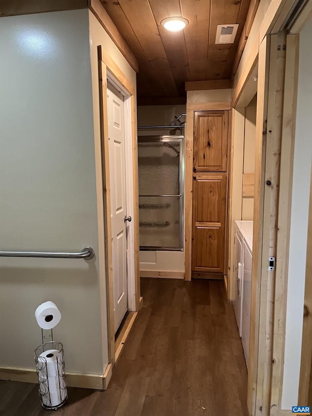 full bath featuring a stall shower, wood finished floors, and baseboards