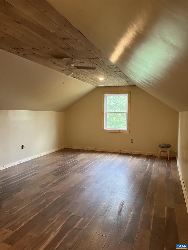 bonus room with vaulted ceiling, dark wood finished floors, baseboards, and a ceiling fan