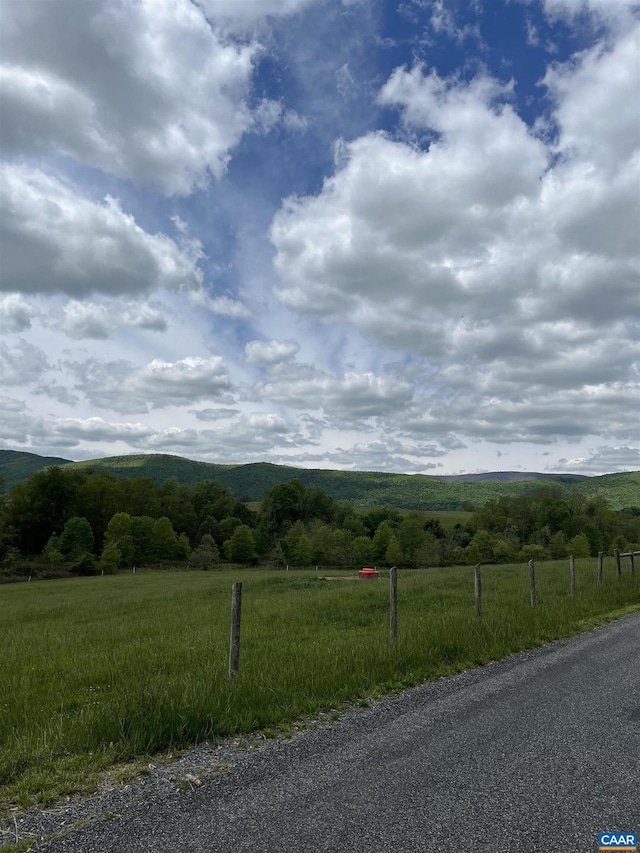 view of mountain background featuring rural landscape