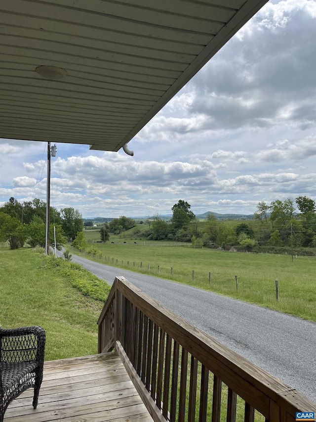 deck with a view of rural / pastoral area and a lawn
