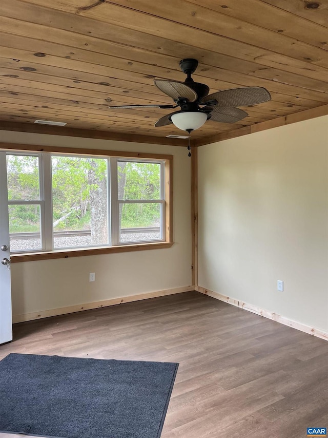 spare room featuring wooden ceiling, a ceiling fan, baseboards, and wood finished floors