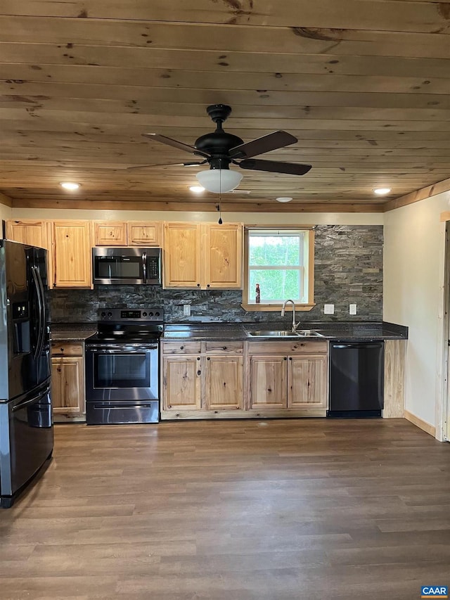 kitchen with black appliances, dark countertops, wooden ceiling, a sink, and light brown cabinetry