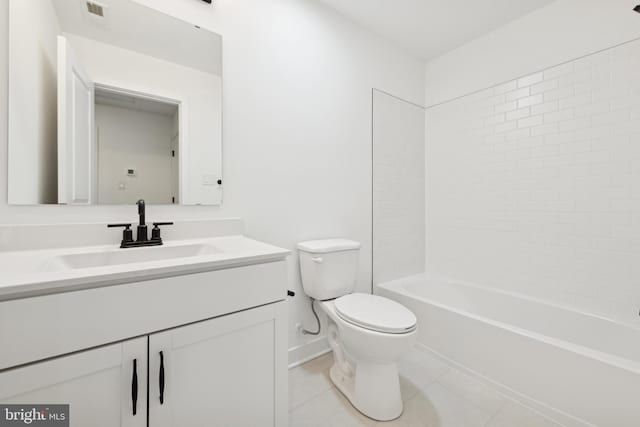 bathroom featuring toilet, vanity, baseboards, tile patterned floors, and shower / washtub combination
