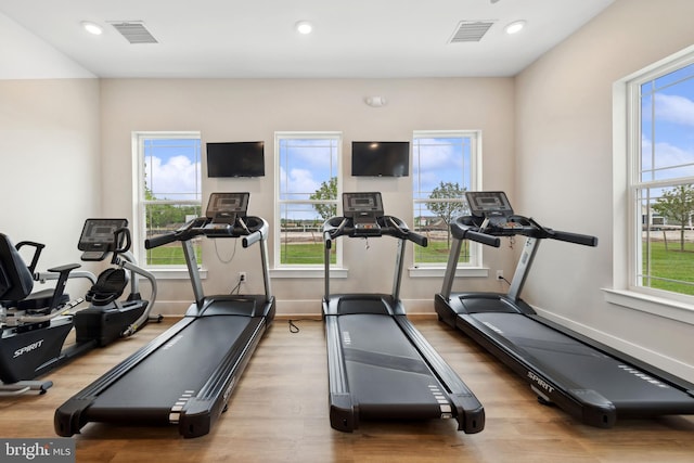 workout area with wood finished floors, recessed lighting, and baseboards