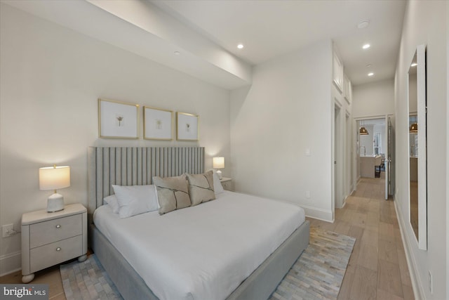 bedroom featuring light wood finished floors, recessed lighting, and baseboards