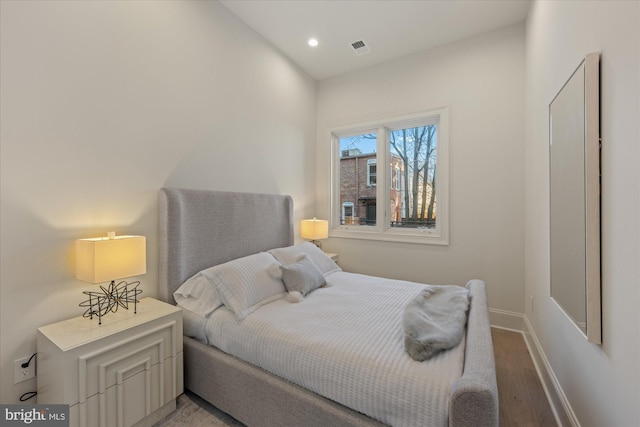 bedroom with light wood-type flooring, baseboards, and recessed lighting