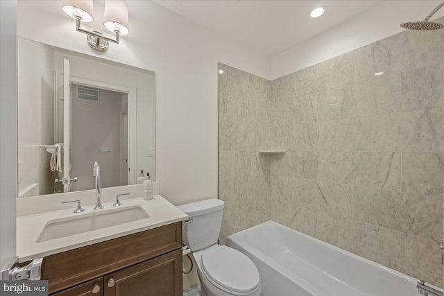 bathroom featuring toilet, vanity, and  shower combination