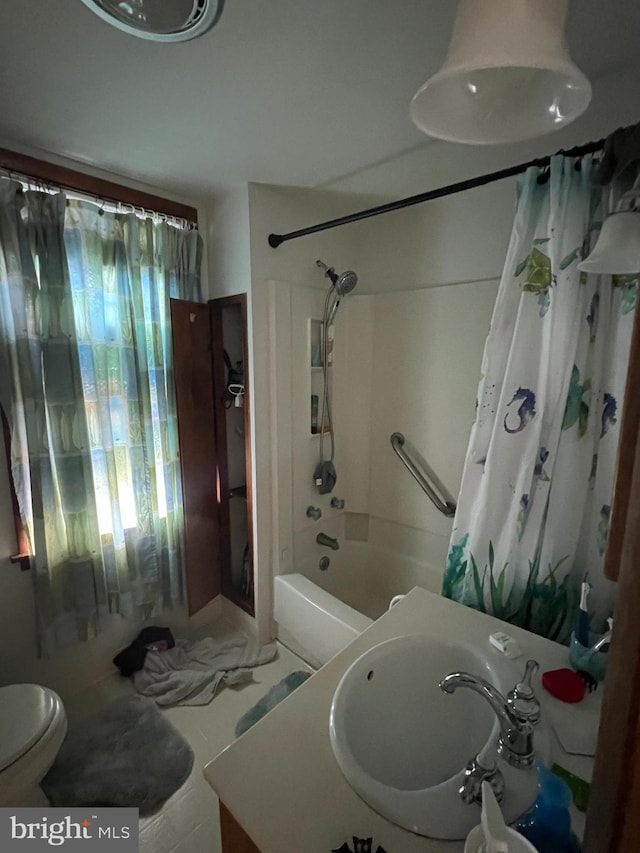 bathroom featuring toilet, shower / tub combo, and vanity