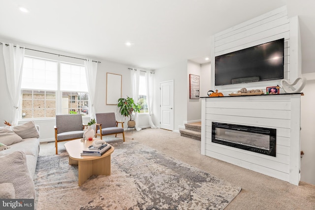 2314 Emerson Ln, Fredericksburg, VA 22401 - living area featuring a glass covered fireplace, carpet floors, recessed lighting, stairway, and baseboards