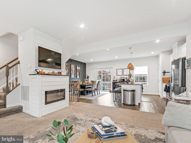2314 Emerson Ln, Fredericksburg, VA 22401 - living room featuring recessed lighting, stairway, a glass covered fireplace, wood finished floors, and baseboards