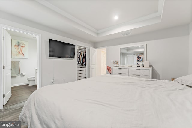 2314 Emerson Ln, Fredericksburg, VA 22401 - bedroom featuring ornamental molding, wood finished floors, ensuite bathroom, a walk in closet, and a tray ceiling
