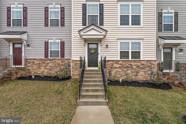 2314 Emerson Ln, Fredericksburg, VA 22401 - view of front facade with stone siding, a standing seam roof, and a front lawn
