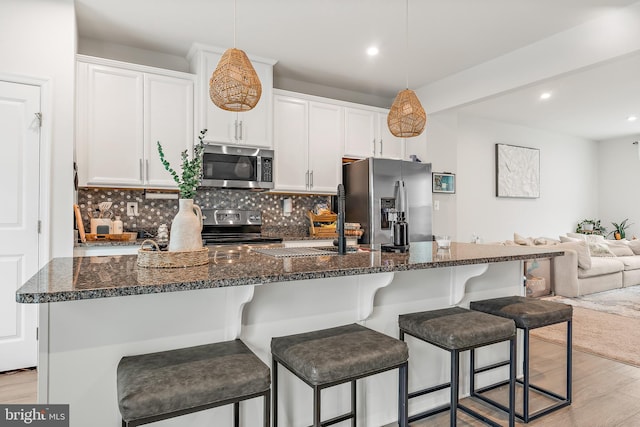 2314 Emerson Ln, Fredericksburg, VA 22401 - kitchen featuring appliances with stainless steel finishes, light wood-style flooring, open floor plan, decorative backsplash, and recessed lighting