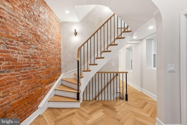728 S Warnock St, Philadelphia, PA 19147 - staircase featuring baseboards, brick wall, arched walkways, and recessed lighting