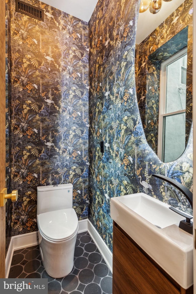 728 S Warnock St, Philadelphia, PA 19147 - half bathroom with baseboards, toilet, vanity, and wallpapered walls
