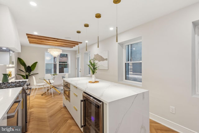 728 S Warnock St, Philadelphia, PA 19147 - kitchen with wine cooler, stainless steel range with gas cooktop, recessed lighting, hanging light fixtures, and white cabinetry